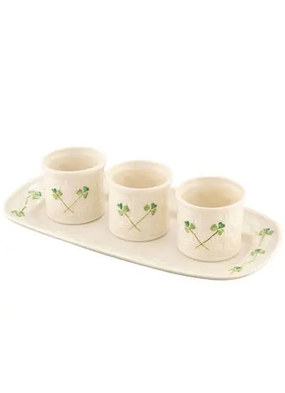 Three ceramic pots with green leaf designs, aligned on a matching elongated tray, all set against a white background.